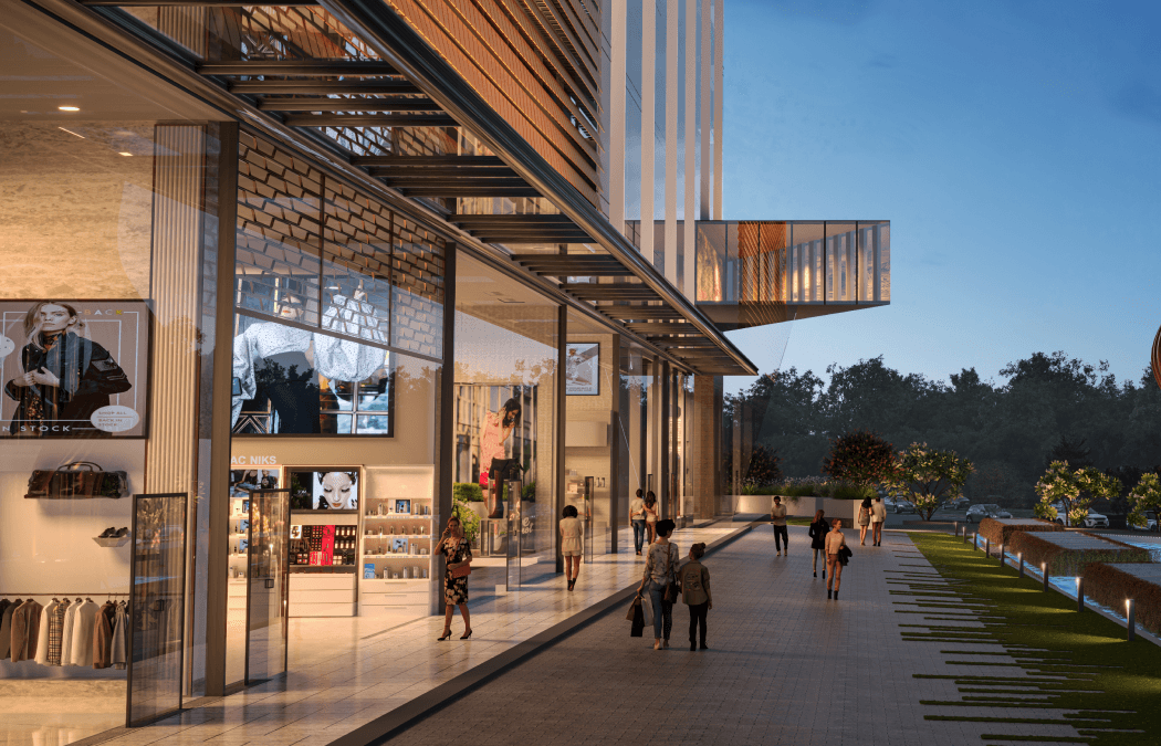 Retail promenade with storefronts along the podium